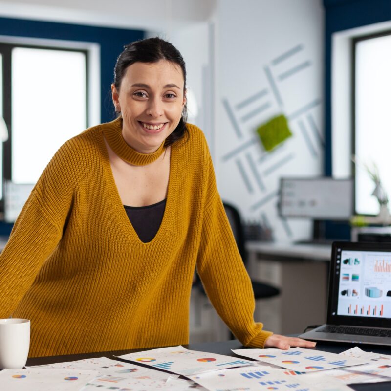 Happy manager standing in office of start up company