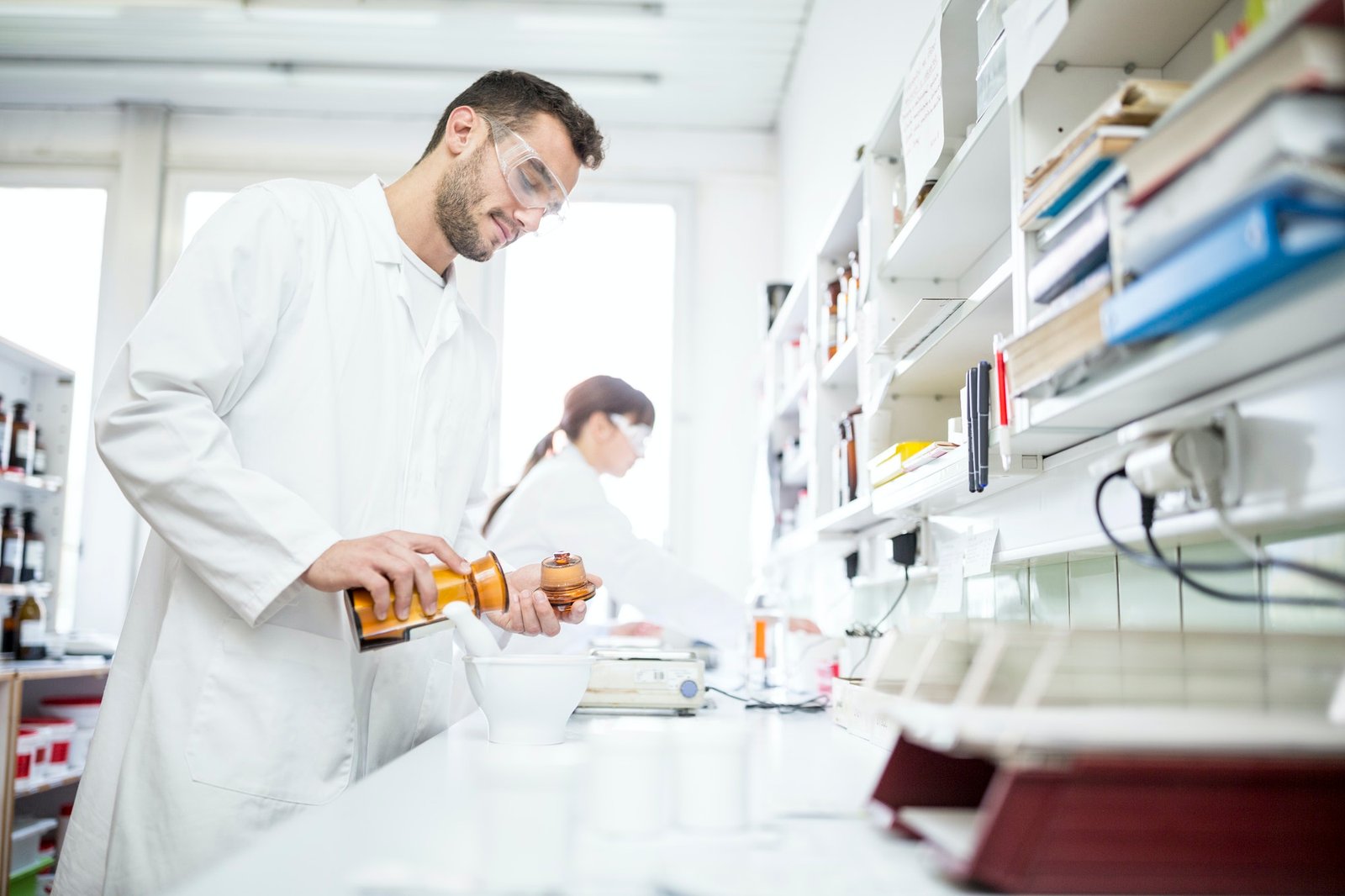 Man and woman working in laboratory of a pharmacy