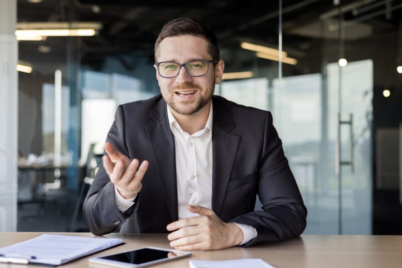 Portrait of a young businessman, a business coach conducts training and online training