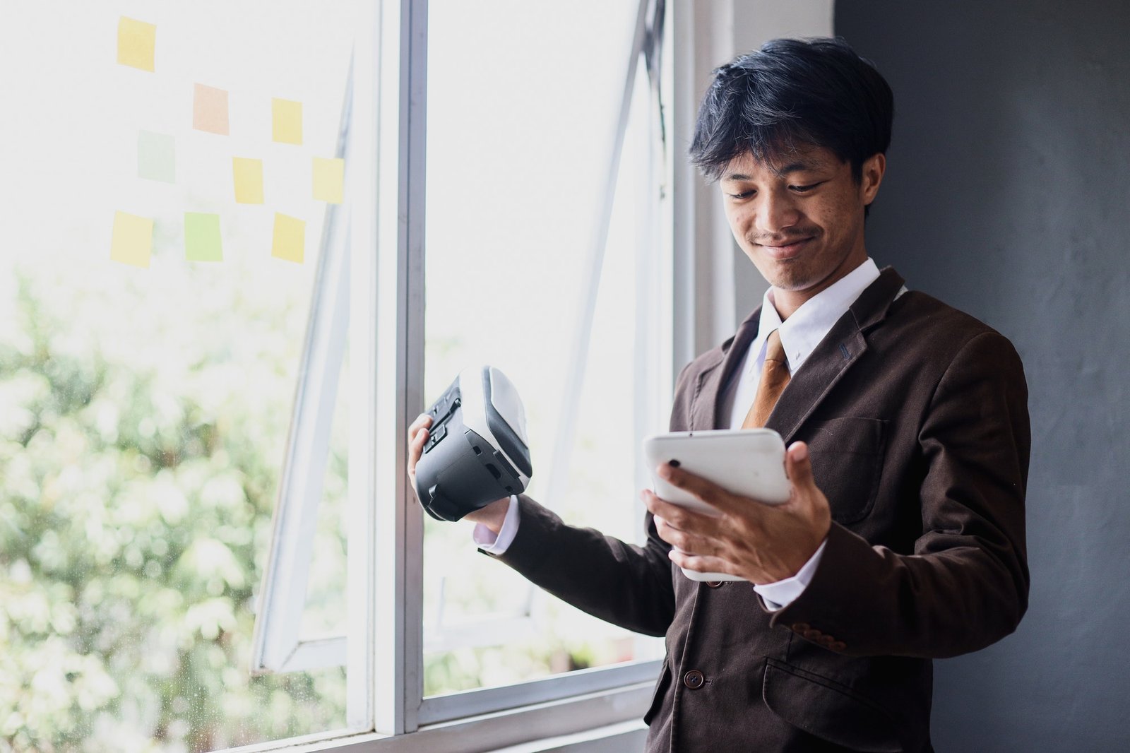 Young businessman holding vr google