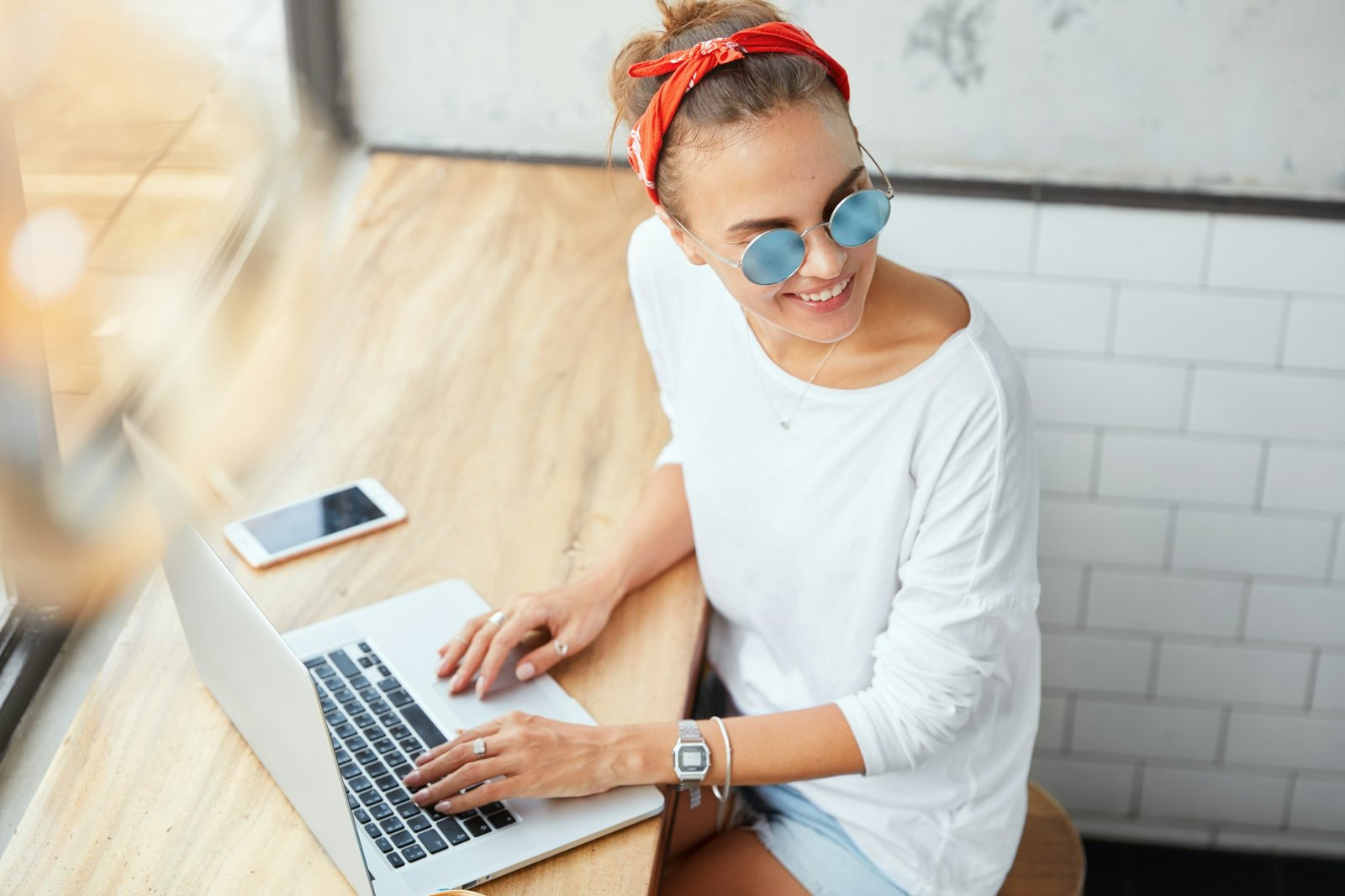 Stylish skilled female enterpreneur makes research for successful startup, browses information on la