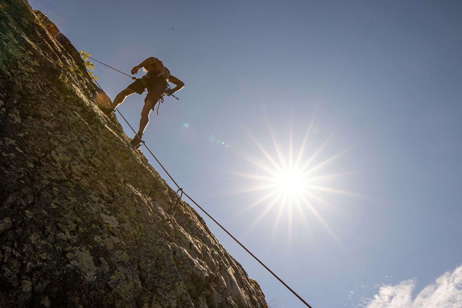 a man climbing up the side of a mountain