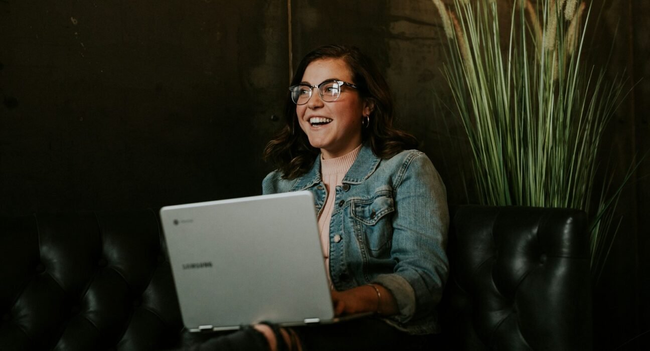 silver laptop on woman's lap